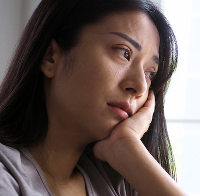 Asian woman sitting inside the house looking out at the window. Woman confused, disappointed, sad and upset SRS-Hair-Loss-Treatment